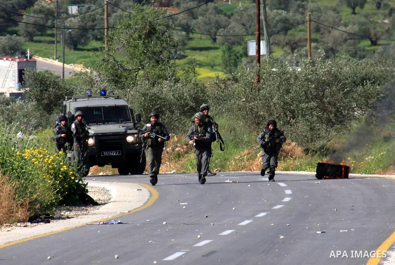 Israeli border policemen run towards Palestinian stone-throwers during clashes outside the West Bank Palestinian village of Awarta near the West Bank city of Nablus, Sunday, April 10, 2011. The Israeli army often carries...