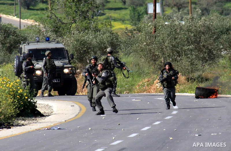 Israeli border policemen run towards Palestinian stone-throwers during clashes outside the West Bank Palestinian village of Awarta near the West Bank city of Nablus, Sunday, April 10, 2011. The Israeli army often carries...