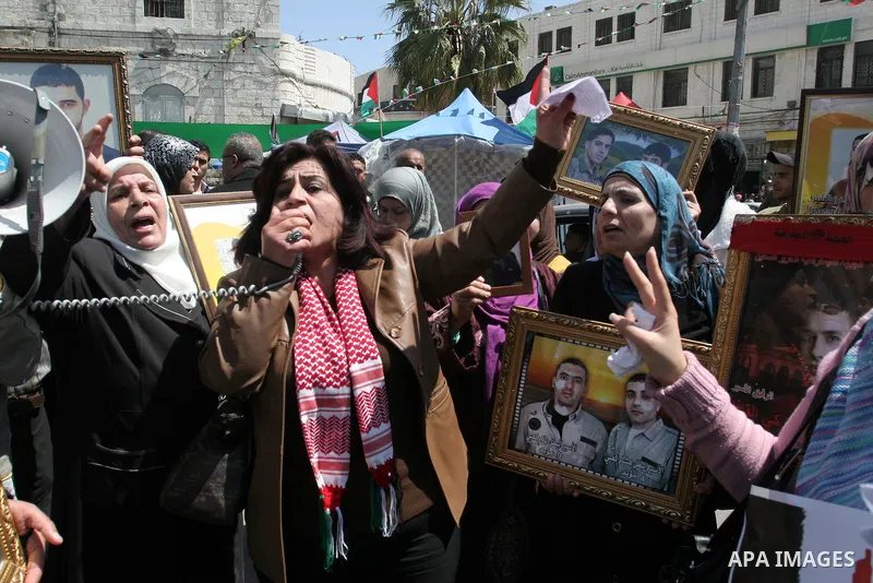 Palestinian women hold pictures of relatives during a protest calling for the release of Palestinian prisoners from Israeli jails, in the West Bank city of Nablus , Sunday, April 10, 2011. Israel currently holds about 8,...
