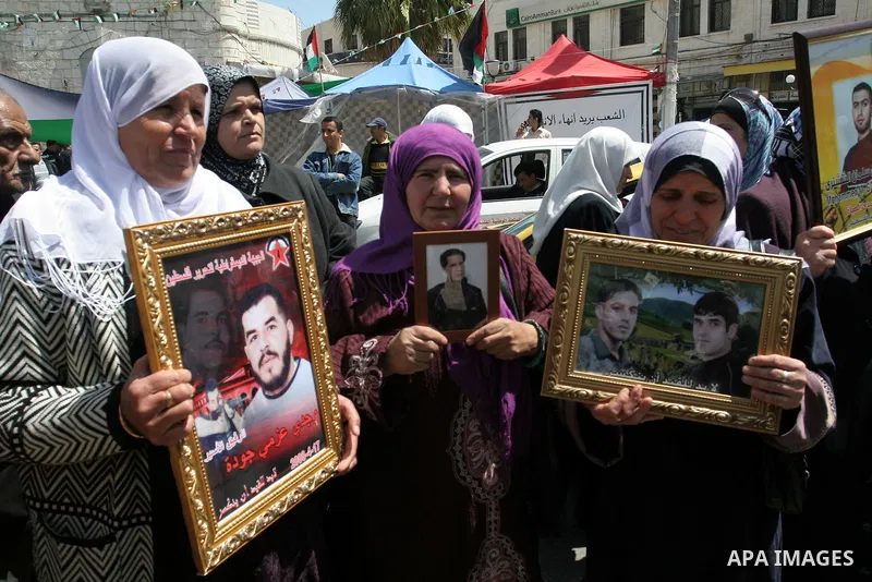Palestinian women hold pictures of relatives during a protest calling for the release of Palestinian prisoners from Israeli jails, in the West Bank city of Nablus , Sunday, April 10, 2011. Israel currently holds about 8,...