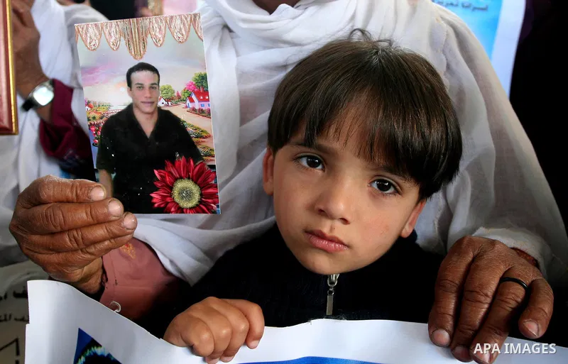 Palestinians hold pictures of jailed relatives during a protest in Gaza city calling for their release from Israeli prisons on April 11, 2011. Photo by Mohamad Asad