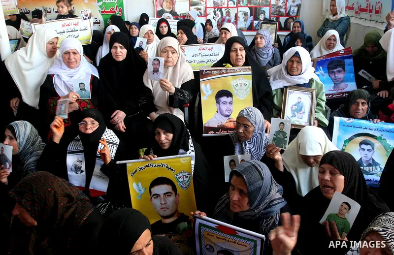 Palestinians hold pictures of jailed relatives during a protest in Gaza city calling for their release from Israeli prisons on April 11, 2011. Photo by Mohamad Asad