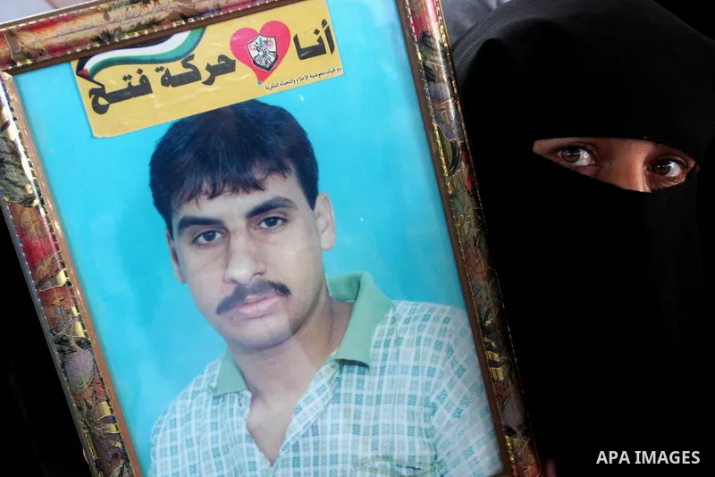 Palestinians hold pictures of jailed relatives during a protest in Gaza city calling for their release from Israeli prisons on April 11, 2011. Photo by Mohamad Asad