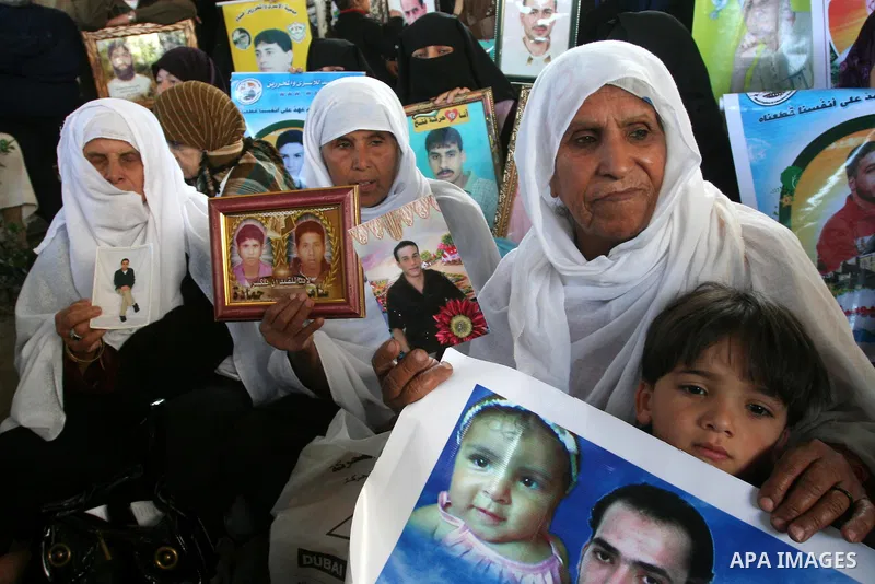 Palestinians hold pictures of jailed relatives during a protest in Gaza city calling for their release from Israeli prisons on April 11, 2011. Photo by Mohamad Asad