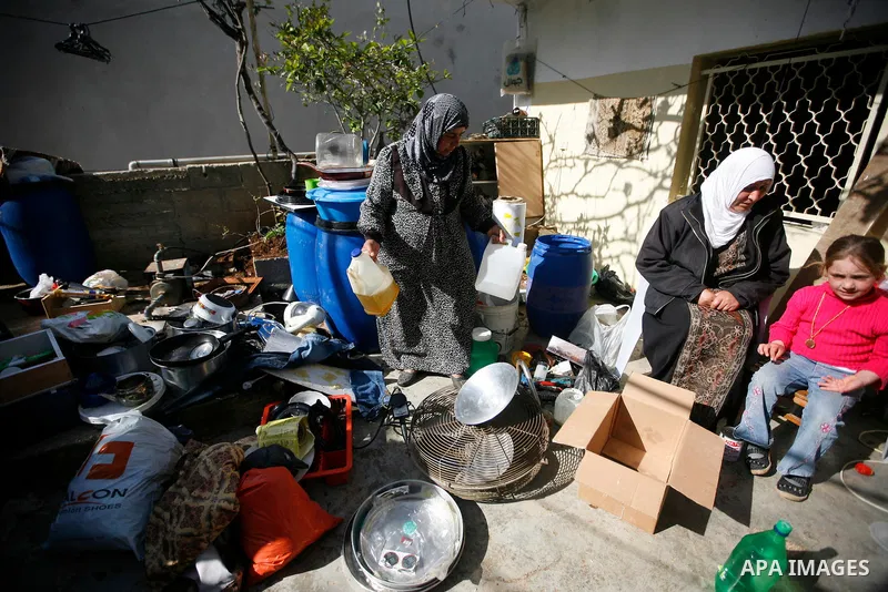 Palestinians inspect damage in their house in the West Bank village of Awarta near Nablus April 11, 2011, which they say was caused by an Israeli army raid. The Israeli army often carries out raids in West Bank towns and...