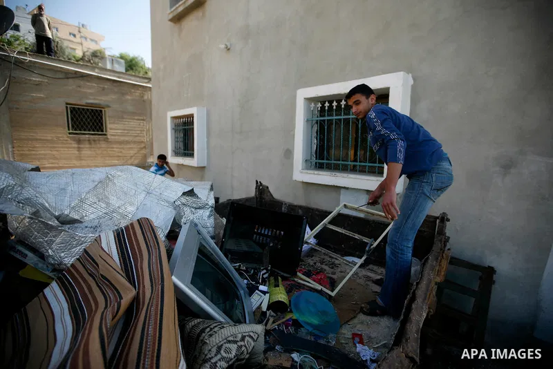Palestinians inspect damage in their house in the West Bank village of Awarta near Nablus April 11, 2011, which they say was caused by an Israeli army raid. The Israeli army often carries out raids in West Bank towns and...