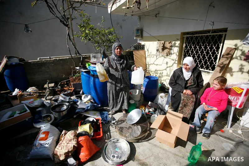 Palestinians inspect damage in their house in the West Bank village of Awarta near Nablus April 11, 2011, which they say was caused by an Israeli army raid. The Israeli army often carries out raids in West Bank towns and...