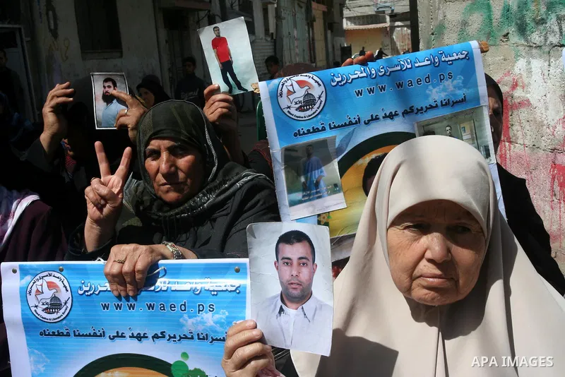 Palestinian of jailed relatives take part in a protest in front of the oldest Gazan prisoner's house Salim al-Keali to mark the Prisoner Day in Gaza city on April 11, 2011. Photo by Mohamad Asad