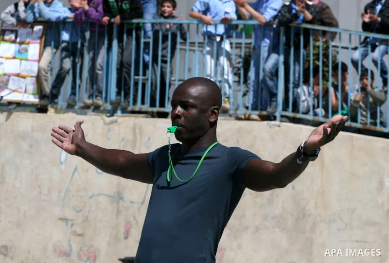 Former French soccer player Lilian Thuram visits a school in the West bank refugee camp of Kalandia, on 11 April 2011. Thuram is visiting the Palestinian territory in support of the education programme funded by France t...