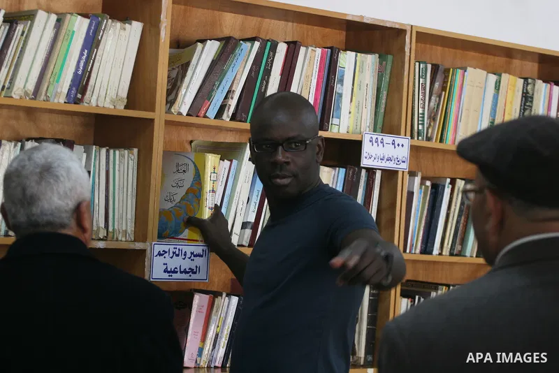 Former French soccer player Lilian Thuram visits a school in the West bank refugee camp of Kalandia, on 11 April 2011. Thuram is visiting the Palestinian territory in support of the education programme funded by France t...