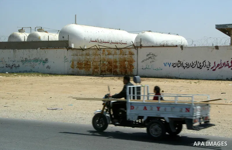 A Palestinian man rides his motorcycle past a closed natural gas station in Rafah, southern Gaza Strip on April 11,2011, as Gaza Strip suffers from the shortage of natural gas which enter to enclave Strip from Israel . P...