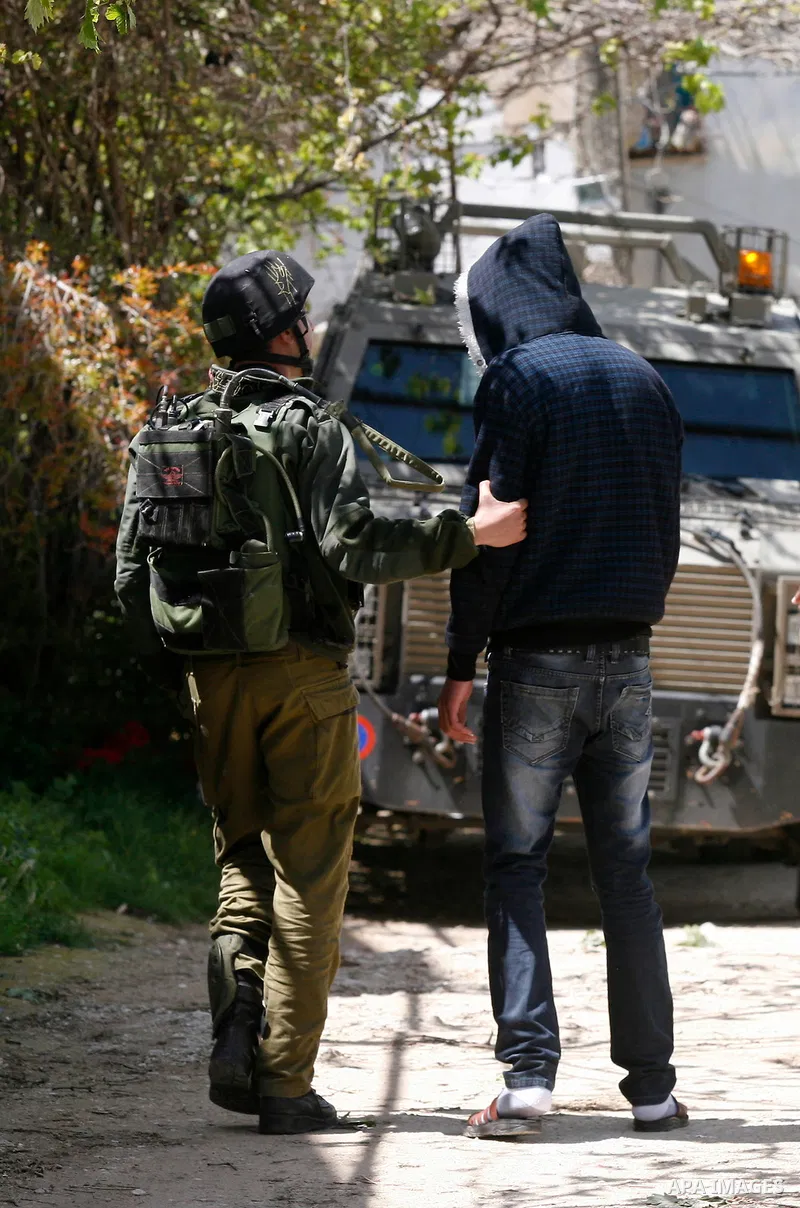Palestinian man during a military operation searching for suspects during a curfew in the West Bank village of Awarta, near Nablus City on 12 April 2011 as the northern West Bank village has been the centre of a massive...