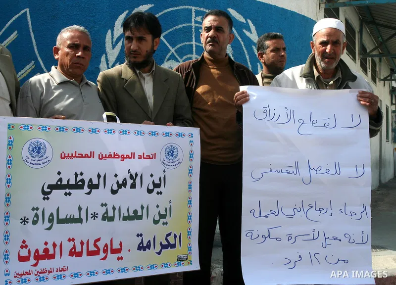 Palestinian UNRWA employees take part in a protest after a work strike extended to three days in Gaza city on April 13,2011 calling the UNRWA to stop the separation of the employees . Photo by Mohammed Asad