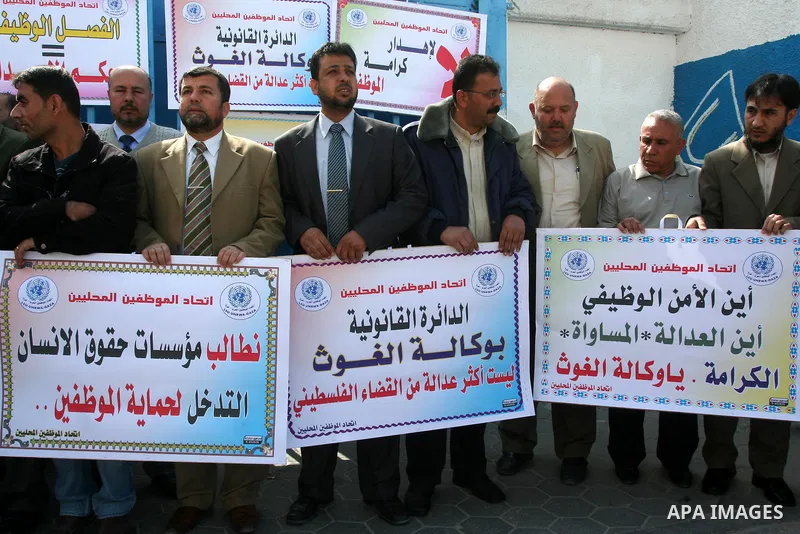 Palestinian UNRWA employees take part in a protest after a work strike extended to three days in Gaza city on April 13,2011 calling the UNRWA to stop the separation of the employees . Photo by Mohammed Asad