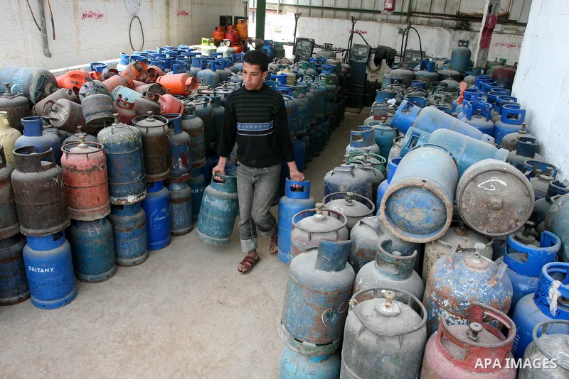 A Palestinian man stands next empty gas canisters at a natural gas station in Gaza city on April 13,2011, as Gaza Strip suffers from the shortage of natural gas which enter to enclave Strip from Israel. Photo by Mohammed...