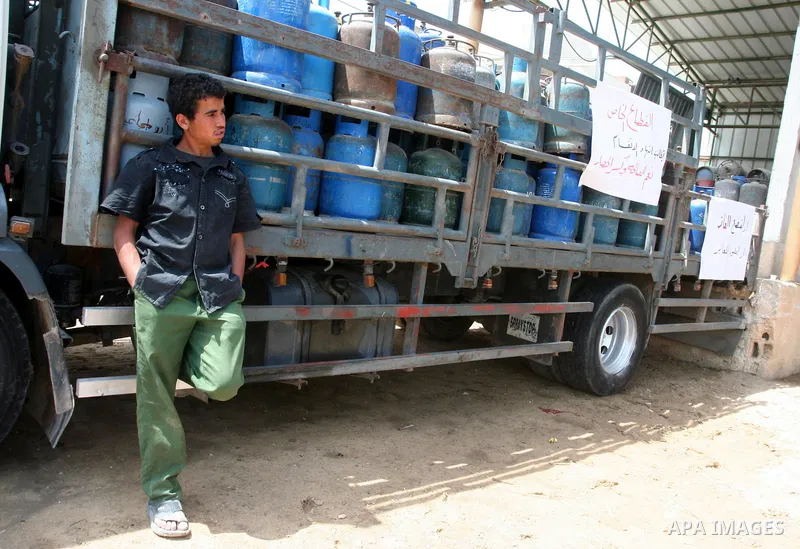 A Palestinian man stands next empty gas canisters at a natural gas station in Gaza city on April 13,2011, as Gaza Strip suffers from the shortage of natural gas which enter to enclave Strip from Israel. Photo by Mohammed...