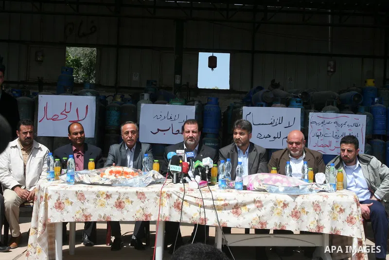 Palestinian members of the Ministry of National Economic attend a press conference next empty gas canisters at a natural gas station in Gaza city on April 13,2011, as Gaza Strip suffers from the shortage of natural gas w...
