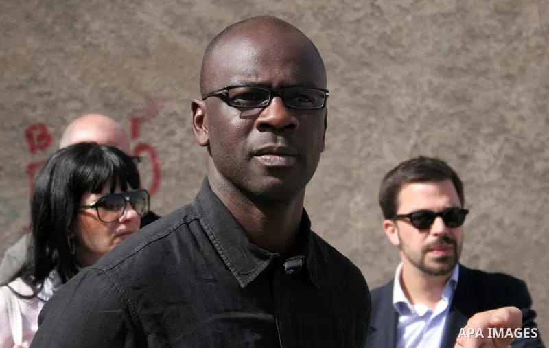 Former French football player Lilian Thuram (C) looks on during a visit to the divided city of Hebron, in the Israeli-occupied West Bank, on April 13, 2011. Thuram is visiting the Palestinian territories in support of th...