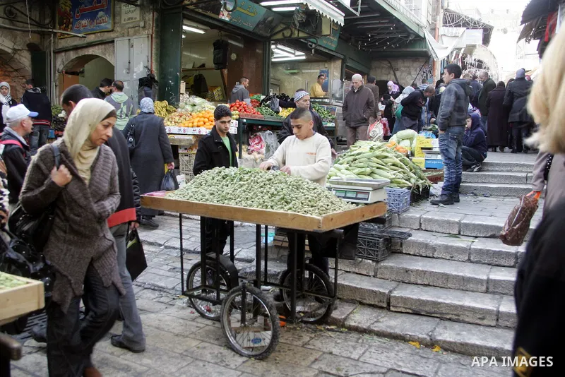 Palestinians shop at the main market in the old city of Jerusalem on April 13, 2011. Photo by Mahfouz Abu Turk
