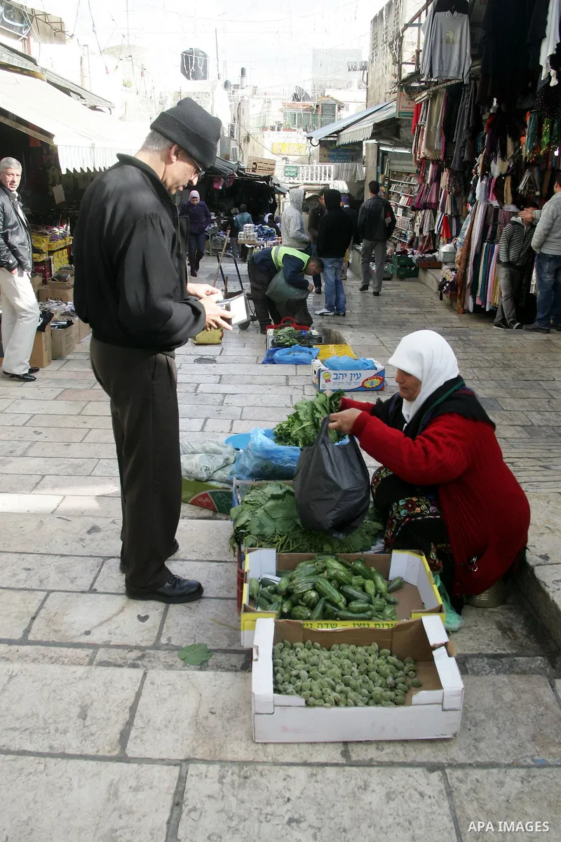 Palestinians shop at the main market in the old city of Jerusalem on April 13, 2011. Photo by Mahfouz Abu Turk