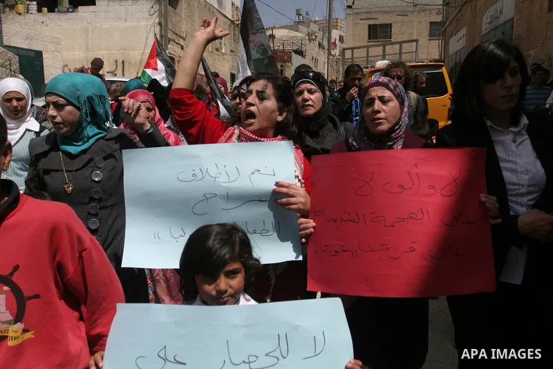 Palestinians protest against the Israeli army's detention of Juliana Awad in the West Bank village of Awarta near Nablus, Thursday, April 14, 2011. Palestinian residents in Awarta say Awad was detained earlier in the wee...