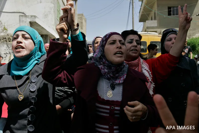 Palestinians protest against the Israeli army's detention of Juliana Awad in the West Bank village of Awarta near Nablus, Thursday, April 14, 2011. Palestinian residents in Awarta say Awad was detained earlier in the wee...