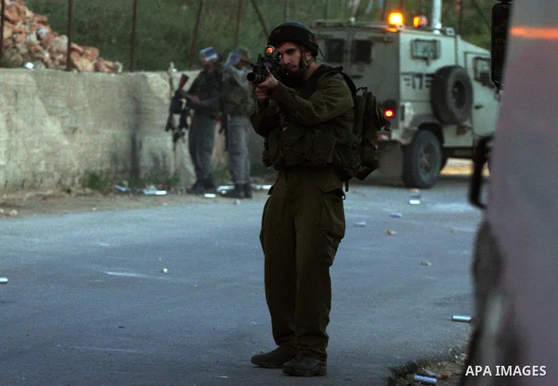 Israeli soldiers fire tear gas toward Palestinian youths on the outskirts of the West Bank city of Ramallah, Thursday, April 14, 2011. According to the army Palestinians threw stones at Israeli troops during a routine op...