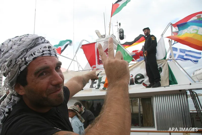 This October 29, 2008 file photo shows Italian peace activist Vittorio Arrigoni at the port in Gaza City celebrating the arrival of the 20-metre (65-foot) ship "Dignity" that departed from Cyprus the previous day to prot...