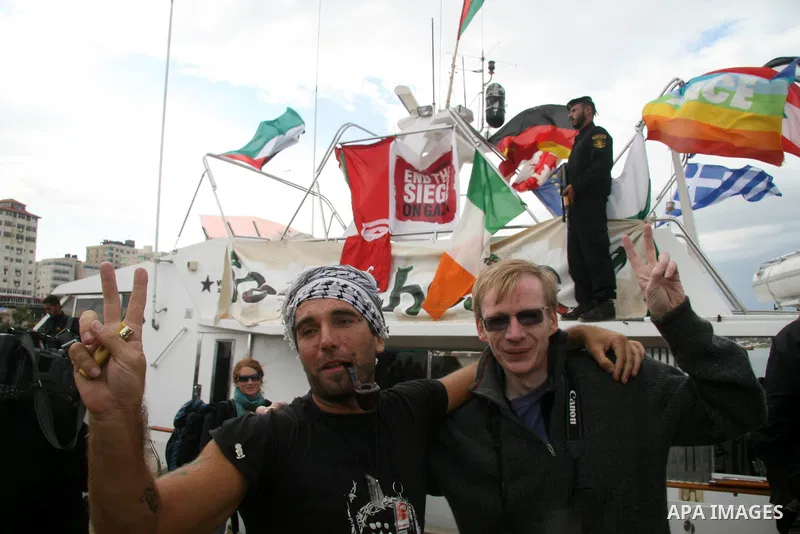This October 29, 2008 file photo shows Italian peace activist Vittorio Arrigoni at the port in Gaza City celebrating the arrival of the 20-metre (65-foot) ship "Dignity" that departed from Cyprus the previous day to prot...