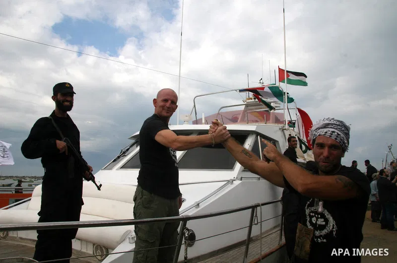This October 29, 2008 file photo shows Italian peace activist Vittorio Arrigoni at the port in Gaza City celebrating the arrival of the 20-metre (65-foot) ship "Dignity" that departed from Cyprus the previous day to prot...