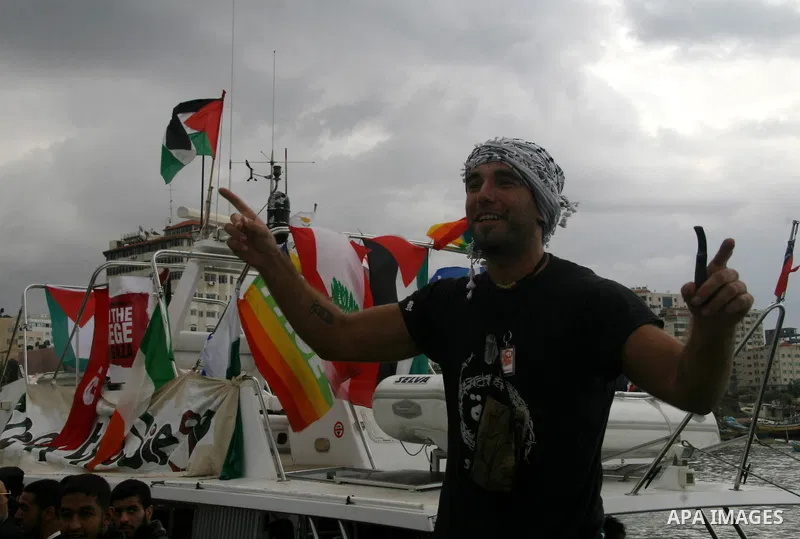 This October 29, 2008 file photo shows Italian peace activist Vittorio Arrigoni at the port in Gaza City celebrating the arrival of the 20-metre (65-foot) ship "Dignity" that departed from Cyprus the previous day to prot...