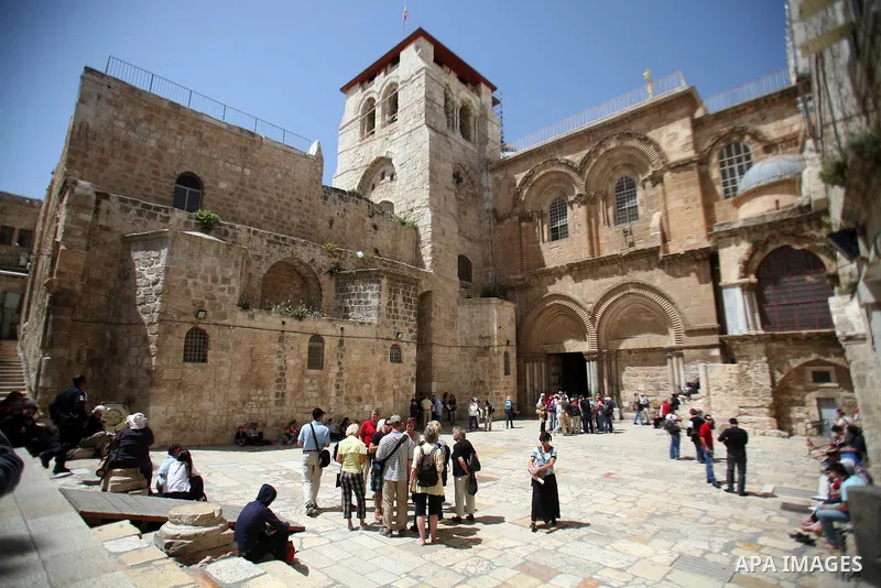 People stand in the Church of the Resurrection in the Old City in East Jerusalem on April 14 2011.Photo by Sliman Khader