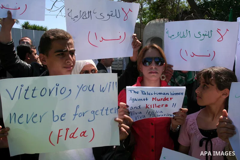 Palestinians hold slogans against the kidnapping and killing of an Italian human rights activist by a Salafist group of radical Islamist, during a protest in Gaza City, on April 15, 2011. International Solidarity Movemen...