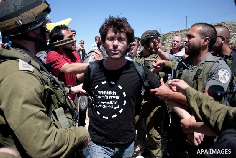 Israeli soldiers arrest a protester during a demonstration against Israel's controversial separation barrier and in support with Vittorio Arrigoni after kidnapping him in Gaza, in the West Bank village of Maasarah, near...
