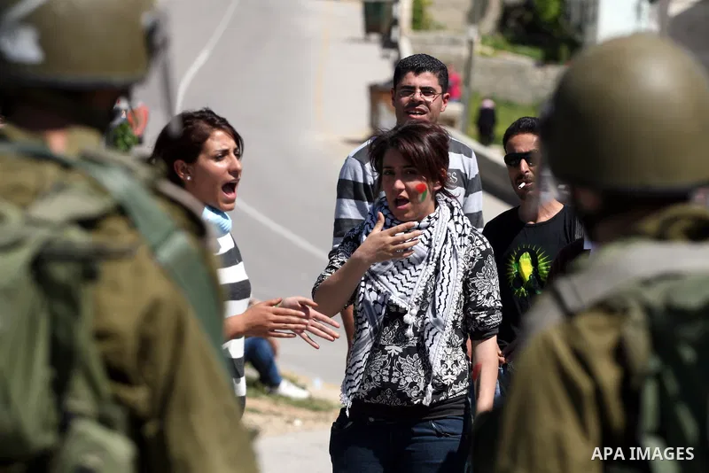 A Palestinian demonstrator takes part in a protest against the expropriation of land to expand the Jewish settlement of Halmish, in the Palestinian village of Nabi Saleh, in the Israeli-occupied West Bank, on April 15, 2...