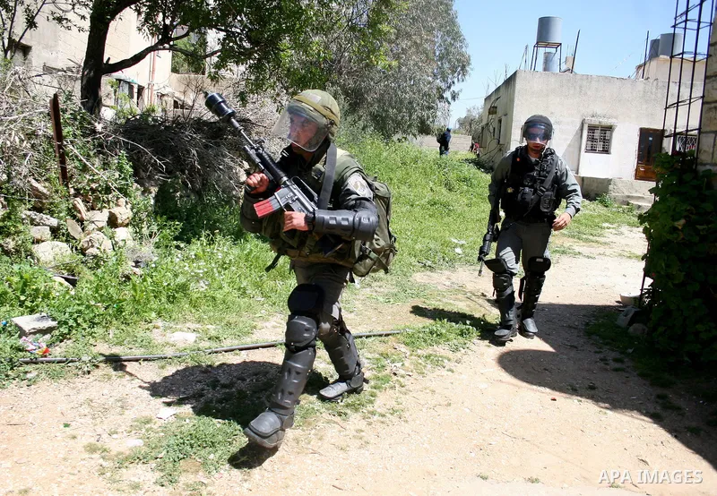 Israeli soldiers take position during a protest by Palestinian and foreign demonstrators against the expropriation of land to expand the Jewish settlement of Halmish, in the Palestinian village of Nabi Saleh, in the Isra...