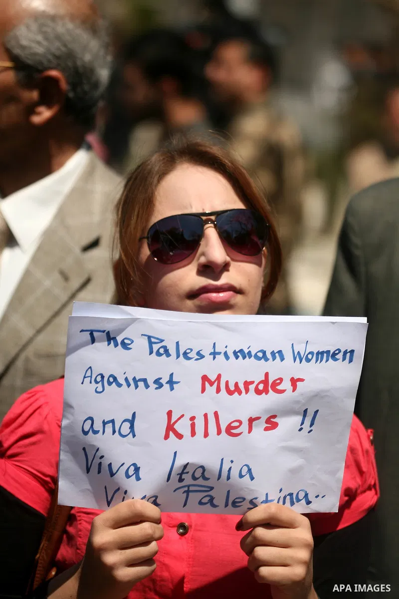Palestinians hold slogans against the kidnapping and killing of an Italian human rights activist by a Salafist group of radical Islamist, during a protest in Gaza City, on April 15, 2011. International Solidarity Movemen...