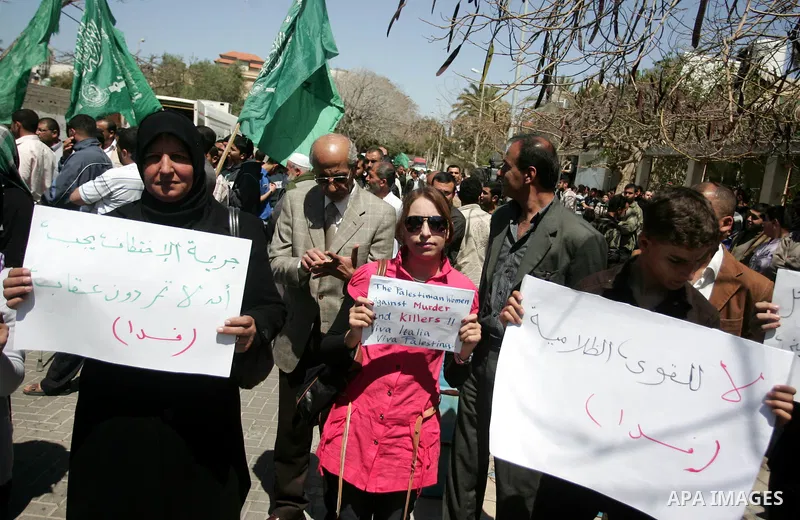 Palestinians hold slogans against the kidnapping and killing of an Italian human rights activist by a Salafist group of radical Islamist, during a protest in Gaza City, on April 15, 2011. International Solidarity Movemen...