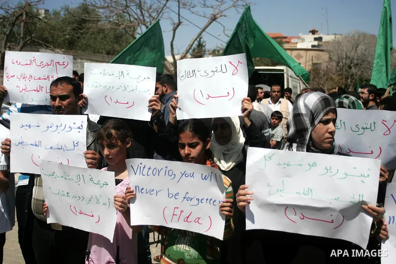 Palestinians hold slogans against the kidnapping and killing of an Italian human rights activist by a Salafist group of radical Islamist, during a protest in Gaza City, on April 15, 2011. International Solidarity Movemen...