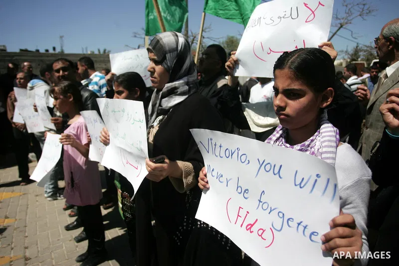 Palestinians hold slogans against the kidnapping and killing of an Italian human rights activist by a Salafist group of radical Islamist, during a protest in Gaza City, on April 15, 2011. International Solidarity Movemen...