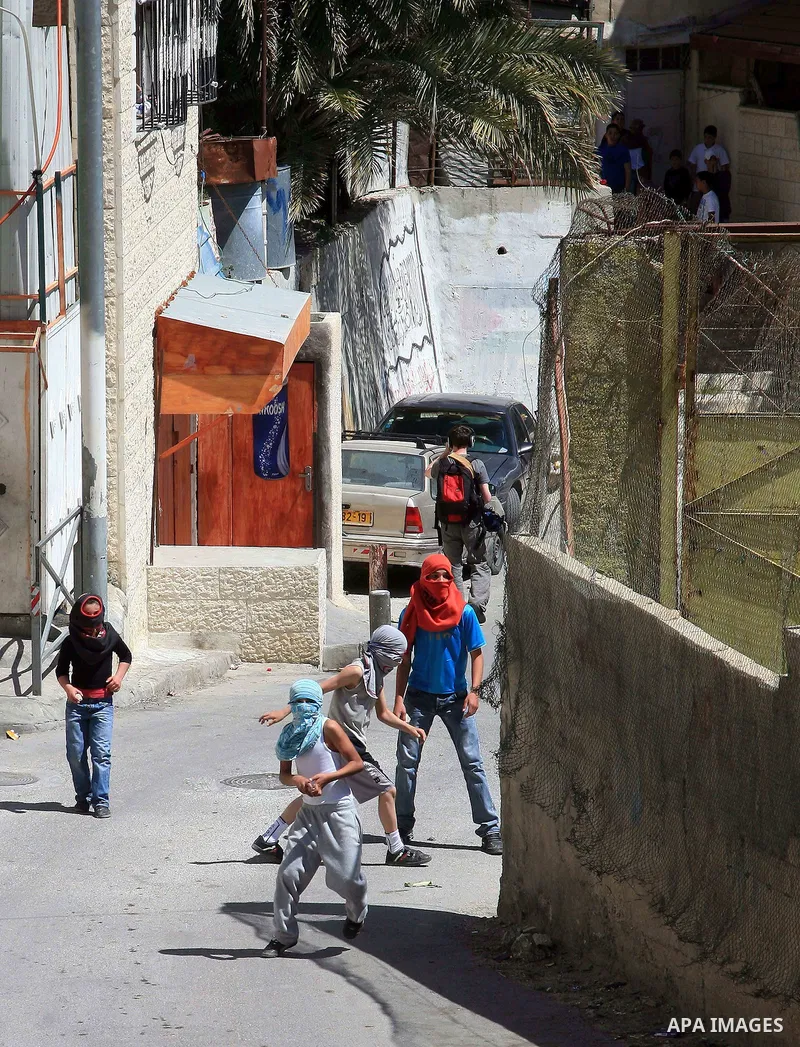 Masked Palestinian youths hurl toward Israeli riot policemen (unseen) in the east Jerusalem neighborhood of Silwan on April 15, 2011 following brief clashes between police and stone throwers. Photo by Sliman Khader
