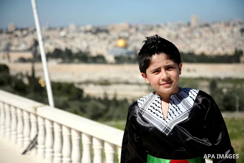 The Palestinian child Issam Bashiti, who was participated in the program Arab's got talent, delivers poetry in front of media in Jerusalem's old city on April 15,2011. The Dome of the Rock shown in the background. Photo...
