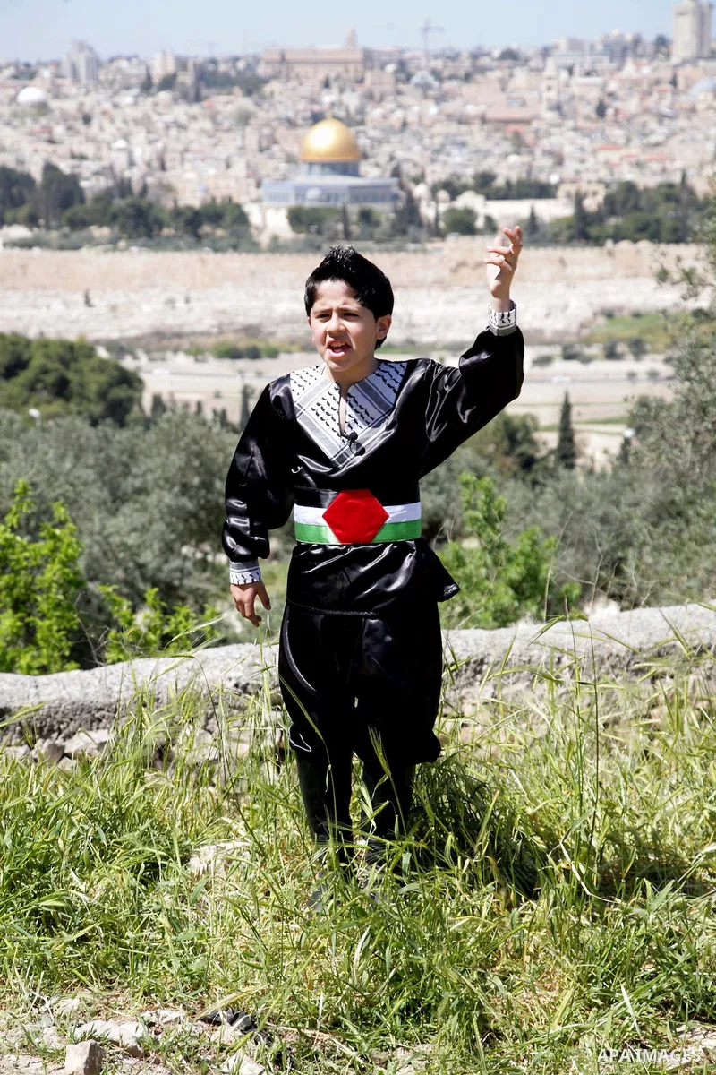 The Palestinian child Issam Bashiti, who was participated in the program Arab's got talent, delivers poetry in front of media in Jerusalem's old city on April 15,2011. The Dome of the Rock shown in the background. Photo...