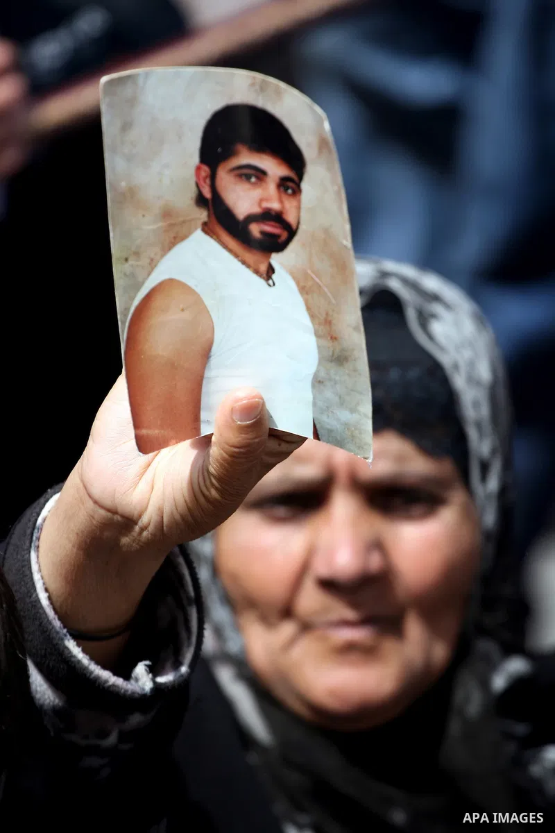 Palestinians hold pictures of their relatives who are imprisoned in an Israeli jail during a protest for the Prisoners Day which will be held on Sunday, in the West Bank city of Ramallah April 16, 2011. Photo by Issam Ri...