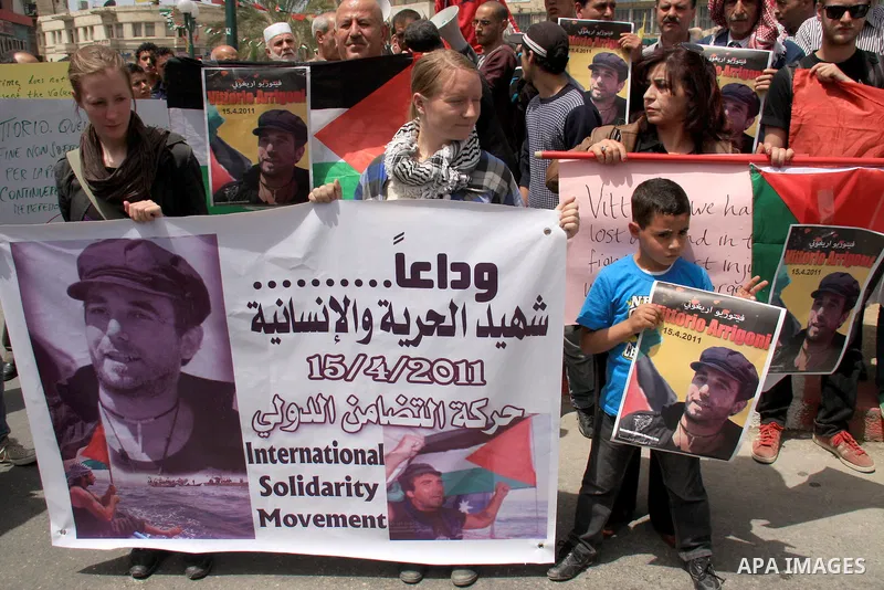Palestinians and foreign activists take part in a protest against the killing of Italian activist Vittorio Arrigoni in the West bank city of Nablus April 16, 2011. Photo by Wagdi Eshtayah