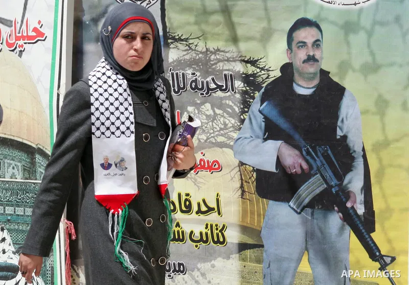 Palestinians students take part during a rally demanding the release of their loved ones from Israeli jails in Al Quds Open University in the West Bank city of Hebron, on April 16, 2011.Photo by Najeh Hashlamoun