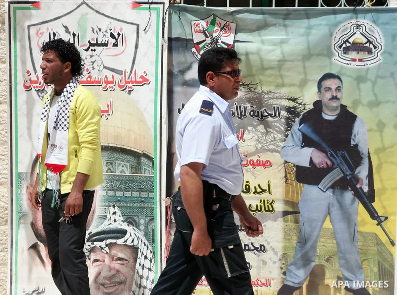 Palestinians students take part during a rally demanding the release of their loved ones from Israeli jails in Al Quds Open University in the West Bank city of Hebron, on April 16, 2011.Photo by Najeh Hashlamoun