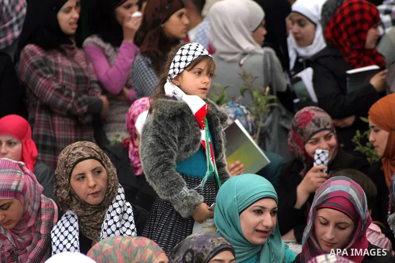 Palestinians students take part during a rally demanding the release of their loved ones from Israeli jails in Al Quds Open University in the West Bank city of Hebron, on April 16, 2011.Photo by Najeh Hashlamoun