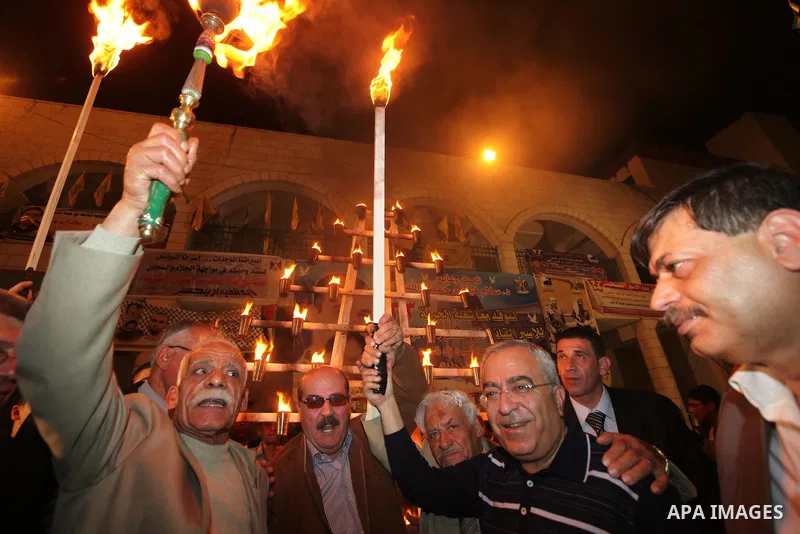 Palestinian Pime Minister, Salam Fayyad lights the flame of freedom to mark the Prisoners Day in the West Bank city of Qalqilya on April 16, 2011. Photo by Mustafa Abu Dayeh