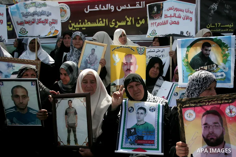 Palestinians hold pictures of their jailed relatives during a rally, one of several taking place across the Israeli occupied West Bank and Gaza Strip, calling for the release of Palestinians being held in Israeli jails,...